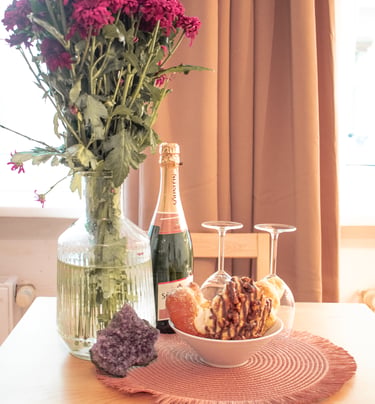a table with a bowl of food and a bottle of wine