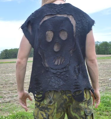 Back view of a person wearing a nuno felted black skull vest 