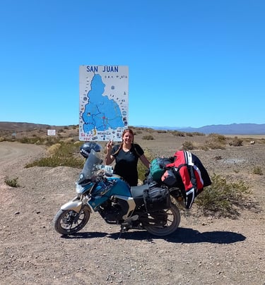 a woman standing next to a motorcycle with a map of the world