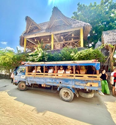 Tourists riding a traditional Zanzibar Daladala, the local bus used to travel to shamba, experiencing authentic village life