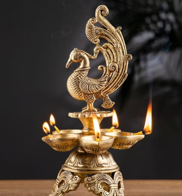a golden colored peacock sitting on a brass lap