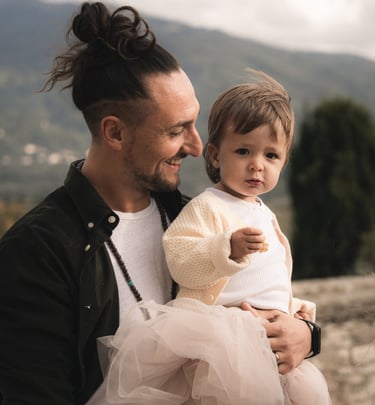 a man with a child on his lap, holding a baby