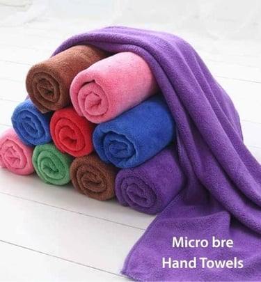 a pile of Micro Bre hand towels on a white floor