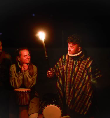 a man holding a torch telling his story and 2 people listening staring at him. Photo by Martin Vähk