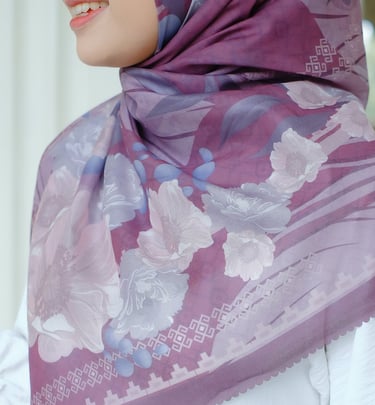 a woman wearing a purple scarf and a white dress