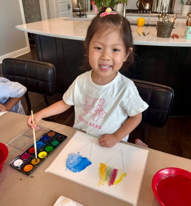 Young girl painting with watercolors at Kelley's Neighborhood Art