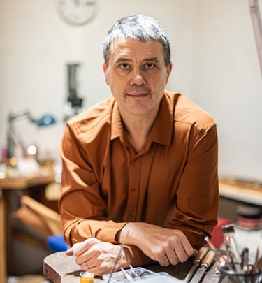 portrait professionnel d'un artisan joaillier dans son atelier