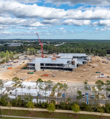 a large building with a crane in the foreground