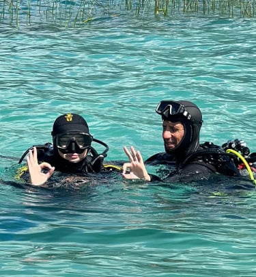 two people in scuba gear in the water