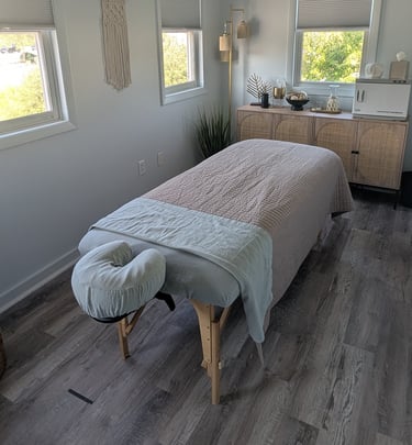 a massage studio room with a massage table