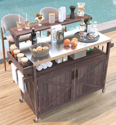 Rustic wood rolling bar cart with a stainless steel top and storage, stocked with drinks by a swimming pool.
