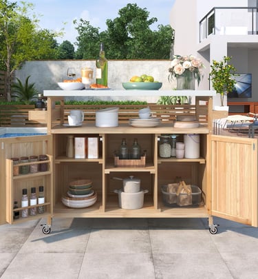 Wooden outdoor kitchen prep station and rolling cart with storage shelves on a patio by a pool.
