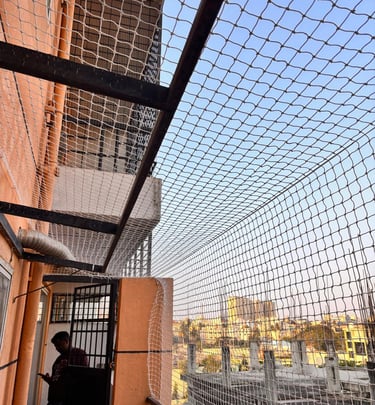 Side view of a rooftop covered with fine mesh pigeon safety netting by Sukumari Safety Nets