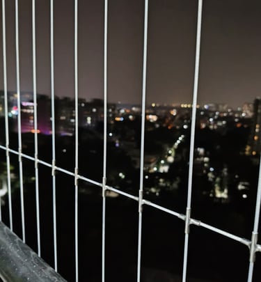 Installation process snapshot capturing careful mounting of invisible grills on a residential balcon