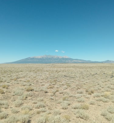 a mountain view of a mountain range with a mountain in the background