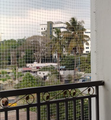 A neat and tidy pigeon net installation blending seamlessly with the apartment exterior