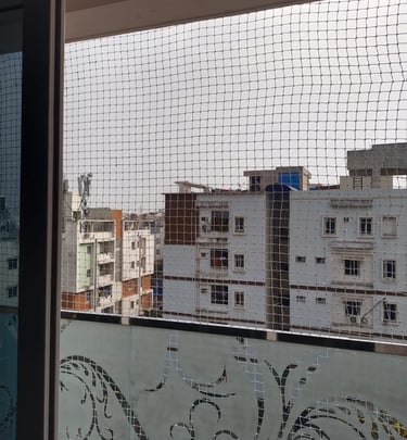 Close-up of a freshly installed pigeon net on an apartment duct in Velacherry