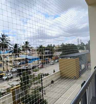 Technician from Arjilli Enterprises carefully installing a balcony safety net in Choolaimedu.