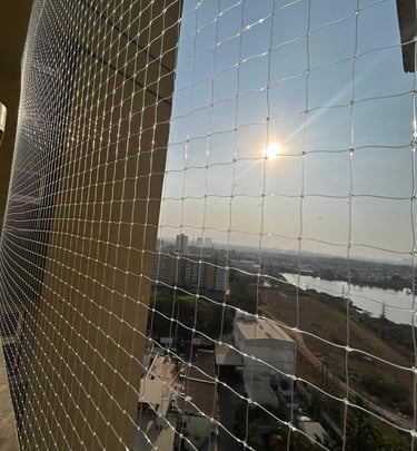 Close-up of a sturdy balcony safety net tightly secured on a residential balcony in Choolaimedu.