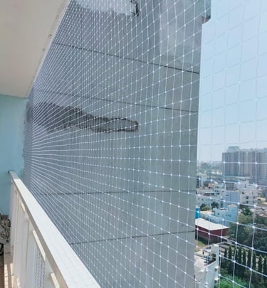 Technician from Arjilli Enterprises fitting a pigeon net carefully around duct pipes