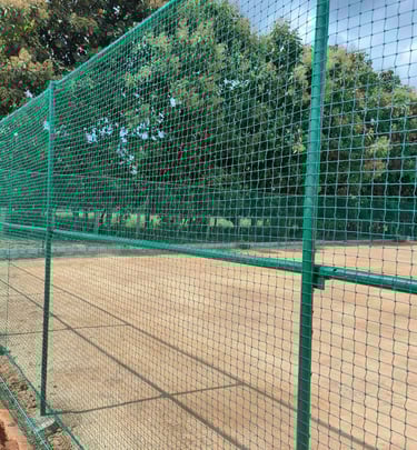 A panoramic shot capturing multiple sports nets installations across different fields, highlighting 