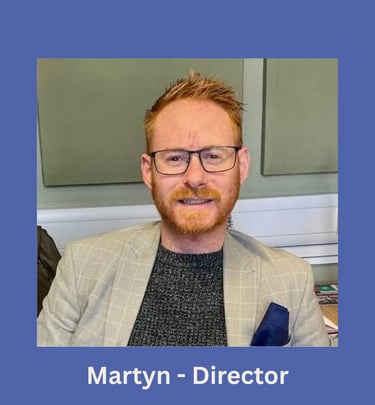 Portrait of Martyn, company director, smiling in an office setting.
