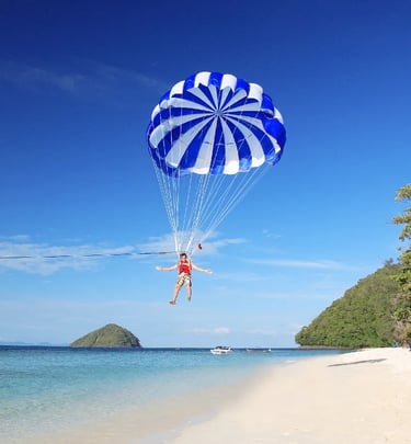 Parasailing adventure at Pattaya beach with clear blue sea and tropical islands