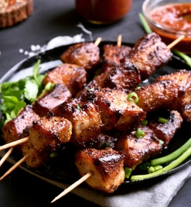 a plate of puerto rican pinchos meat and vegetables on a table