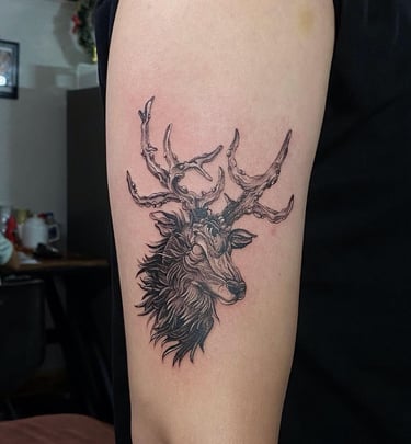 Ghostly elk tattoo on the upper arm with realistic style