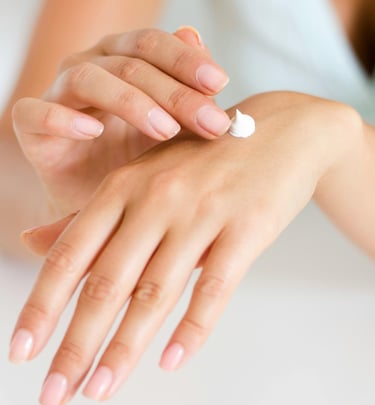 a woman's hands holding a habu secrets cream tube