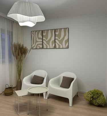 a living room with a white chair and two chairs