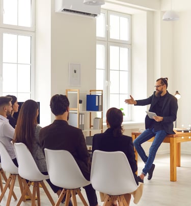 GLm LAW a man in a black shirt is standing in front of a group of people
