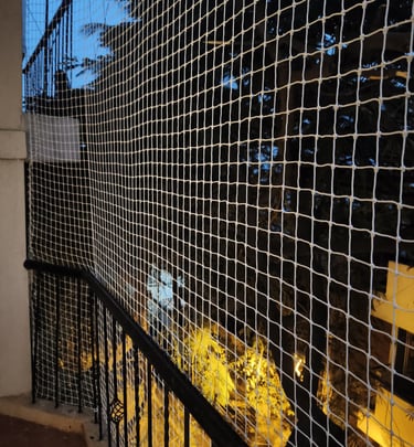 Close-up of a sturdy balcony pigeon net securely installed, showing fine mesh and neat edges