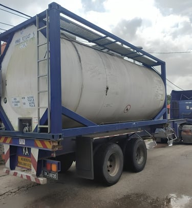 a truck with a tanking tank sitting on the side of a road
