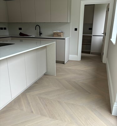 A light oak chevron floor in an open plan kitchen