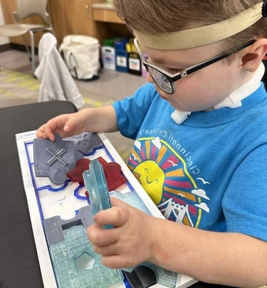 Child exploring a tactile puzzle by DUAL Tools, building sensory and problem-solving skills