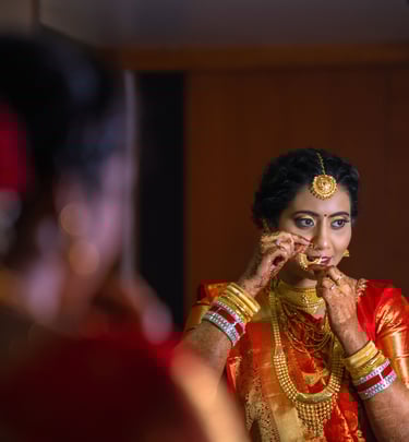 a woman in a red sari and gold jewelry , Wedding photography
