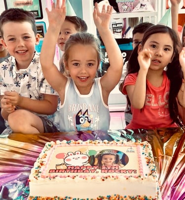 birthday girl and friends at party with birthday cake