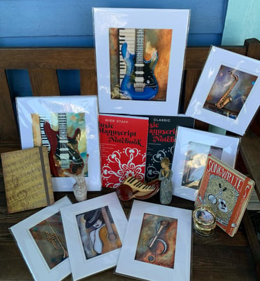 a bunch of greeting cards and framed pictures of guitars and books