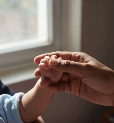 A quiet moment capturing the hands of a mother and child weaving together, symbolizing legacy and hope.
