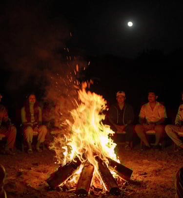 A lively crowd enjoying an outdoor evening event with string lights overhead