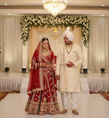 A joyful bride and groom sharing a candid laugh during their vibrant Indian wedding ceremony.