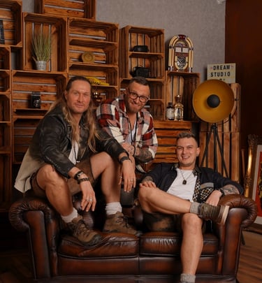 a man and woman sitting on a leather couch