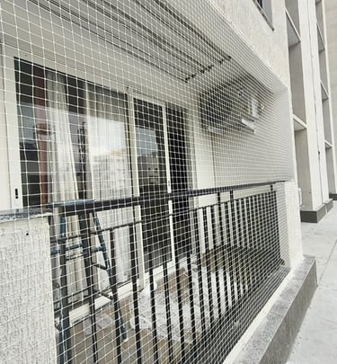 Detail of a duct area covered with a fine mesh net preventing bird entry, with sunlight filtering th