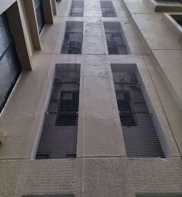 colaba Technician carefully installing a pigeon net on a residential balcony with tools in hand