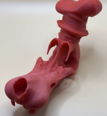 Red 3D printed dragon head figurine with detailed scales and a curved top piece.