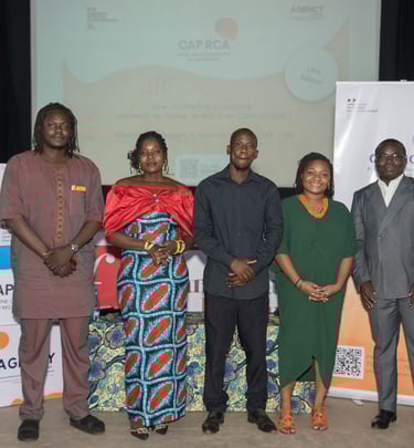Professional group of African business leaders posing together in formal attire in front of a building.