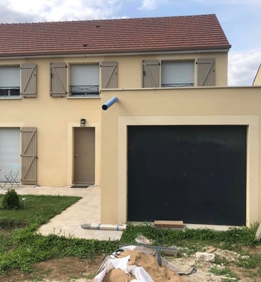 a house with a garage door and a garage door