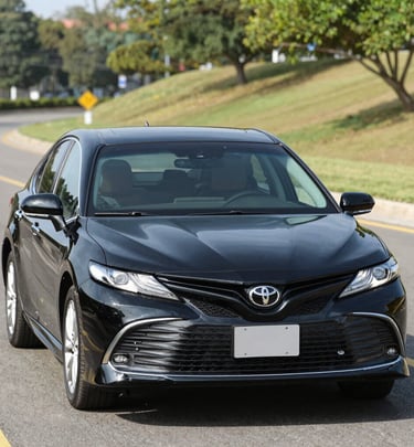 A serene view of the vehicle fleet lined up with the golden hues of sunset reflecting the spiritual journey.