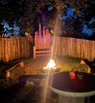 Communal fire pit area sheltered and ready for toating marshmellows